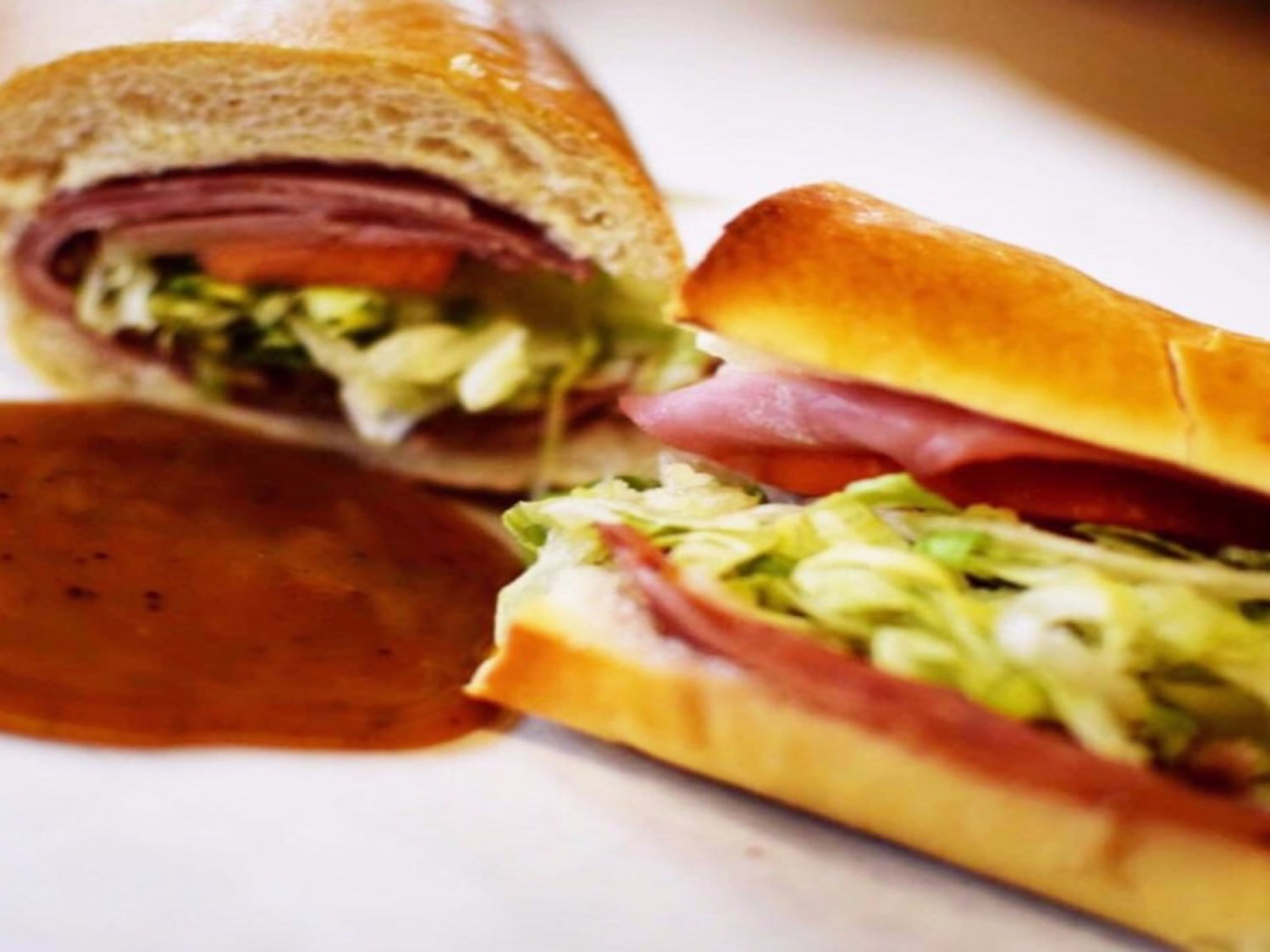 Oven-baked sub sandwich with ham, lettuce and tomato
